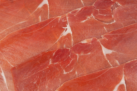 Red ham prosciutto sliced as a backgroundの写真素材
