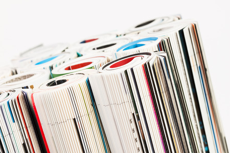 Stack of color magazines on white の写真素材