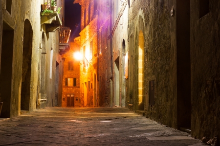 mysterious narrow alley with lanterns at nightの写真素材