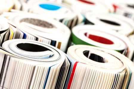 Stack of color magazines on white backgroundの写真素材