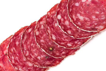 Slices of salami sausages isolated on a white backgroundの写真素材