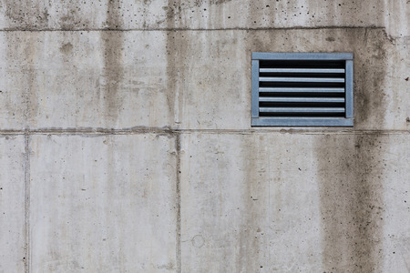 Ventilation grille on a concrete wall texture