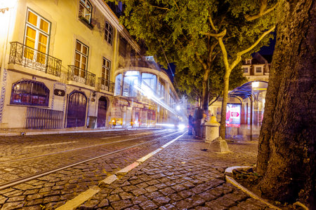 LISBON, PORTUGAL - September 13, 2014: Traditional yellow tram downtown Lisbon by night on September 13, 2014. Trams are used by everyone and also keep the traditional style of the historic center of Lisbon.のeditorial素材