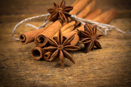 Close up of cinnamon sticks and star anise on rustic wood background