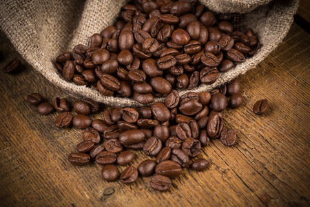 Coffee beans on grunge wooden background. Fresh Roasted coffee beans on vintage tableの写真素材