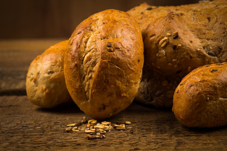Close up of white bread buns over wooden background