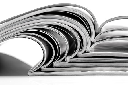 Stack of magazines on white background with reflectionの写真素材