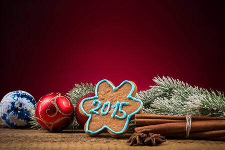 Christmas 2015 cookie with cinnamon and anise on wooden table with red backgroundの写真素材