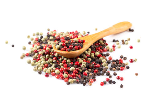 Pepper seasoning mix in wooden spoon isolated on white background cutout
