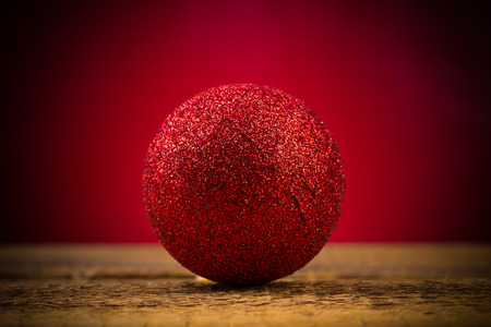 red christmas ball on red background, close upの写真素材
