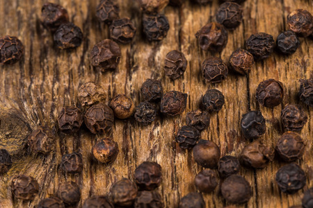 black pepper on a wood background tableの写真素材