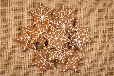 Star shape christmas gingerbread cookies on fabric background