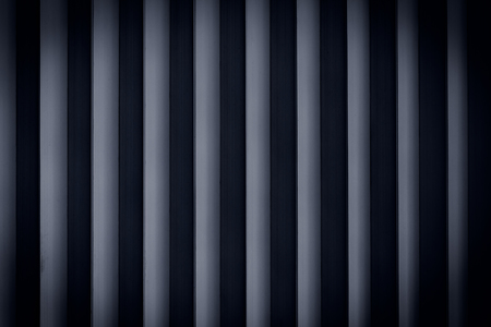 Dark rolling shutter door texture vertical linesの写真素材
