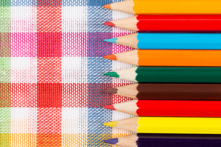 Colour pencils in the glass over colorful backgroundの写真素材