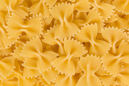 Close up of uncooked farfalle pasta as a backgroundの写真素材
