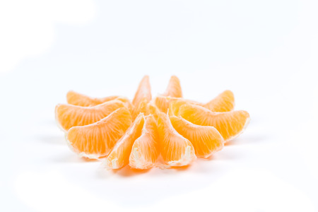 Peeled tangerine or mandarin fruit isolated on white background cutoutの写真素材