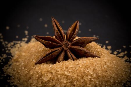 star anise on a background of the tropical brown sugarの写真素材