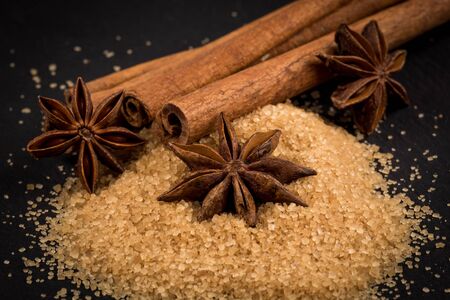 star anise and cinnamon on a background of the tropical brown sugarの写真素材