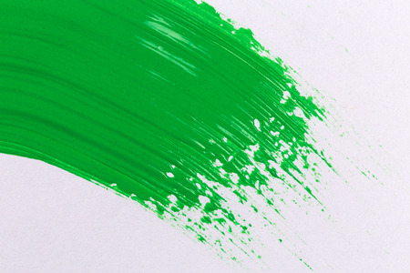 green stroke of the paint brush on white paperの写真素材