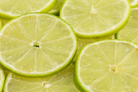 Green background with citrus-fruit of lime slicesの写真素材