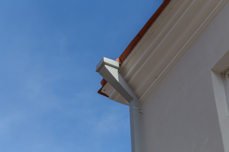 House and old dirty metal roof gutter