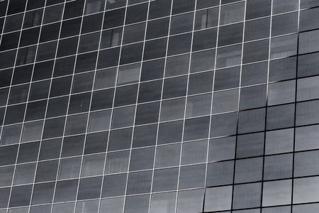 Glass building windows reflection on blue sky