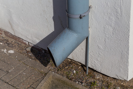 old gutter metal rain drain pipe on the wallの写真素材