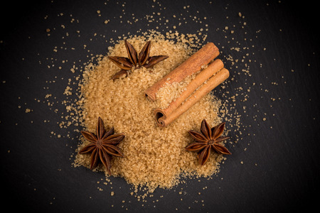 star anise and cinnamon on a background of the tropical brown sugarの写真素材