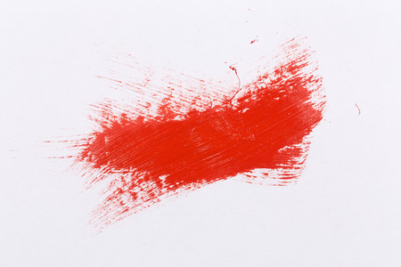 Red stroke of the paint brush on white paperの写真素材