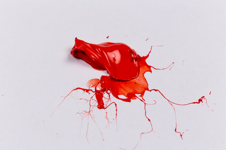 Red stroke of the paint brush on white paperの写真素材