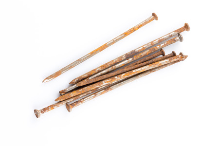 some old rusty nails on white tableの写真素材