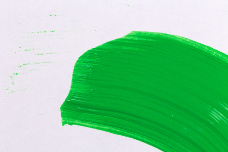 green stroke of the paint brush on white paperの写真素材