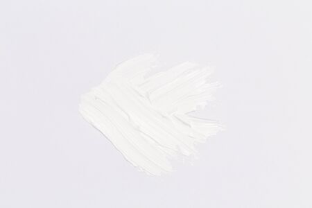 Hand made oil paint brush stroke over the white paper as a design element of a backdropの写真素材