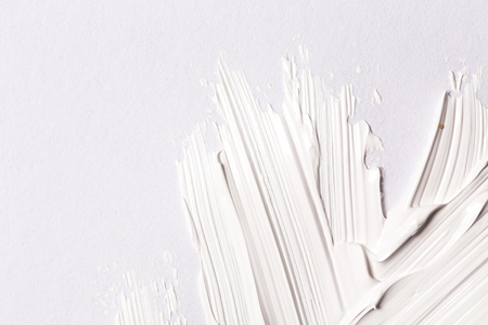 Hand made oil paint brush stroke over the white paper as a design element of a backdropの写真素材