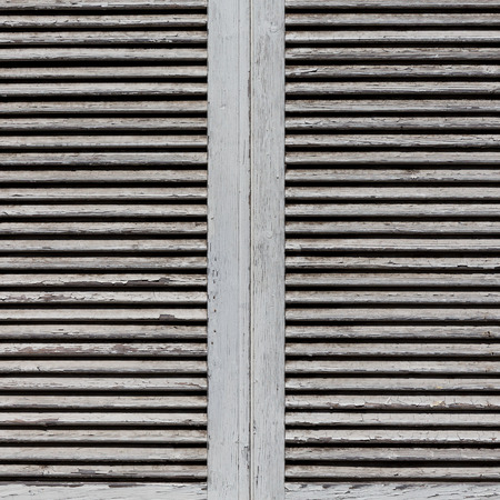 Image of white wooden shutters, covering a window or doorの写真素材