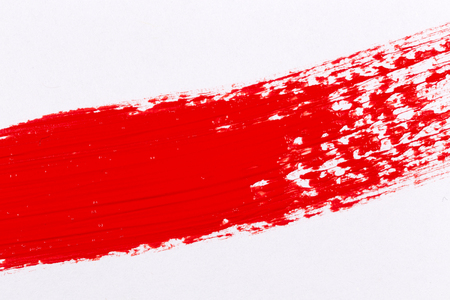 Red paint splash on a white paperの写真素材