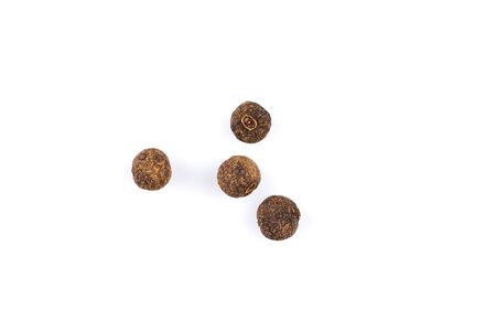 Large black pepper corns isolated on white backgroundの写真素材