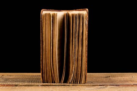 ancient book shot on black backgroundの写真素材