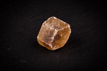 caramelized candy brown sugar on a dark stone board