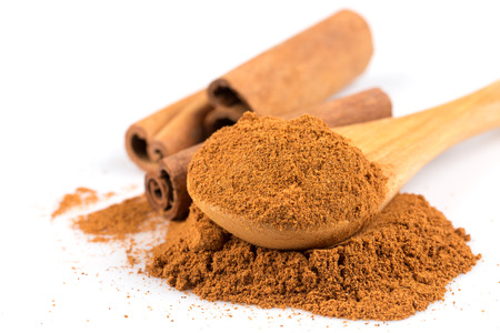cinnamon ground and sticks isolated on a white backgroundの写真素材