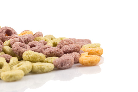 Close up image of colorful cereal against white background