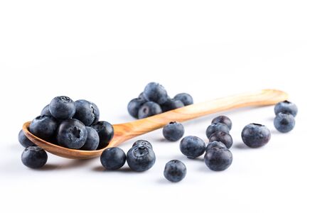Fresh blueberries in wooden spoon on white backgroundの写真素材