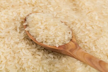 spoon of rice on puffed rice cereal background close upの写真素材