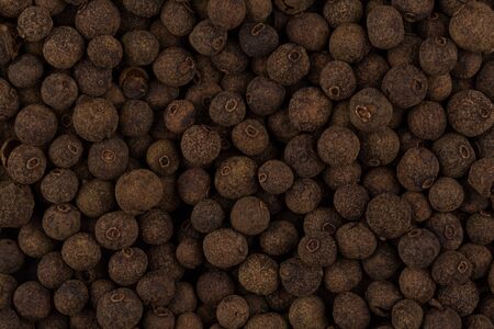 Large black pepper seeds corns as a background