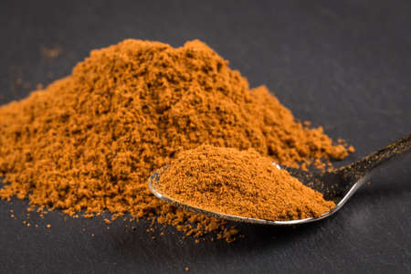 cinnamon sticks with powder on spoon