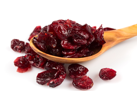 Pieces of dried cranberries isolated on white backgroundの写真素材