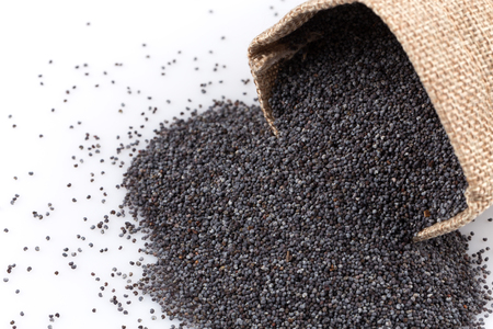 poppy seeds in a sack on a white backgroundの写真素材