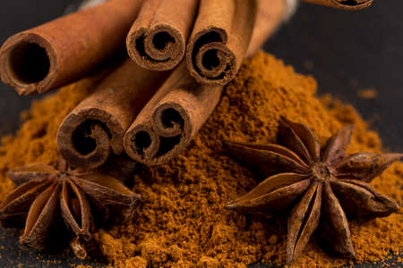 Anise and cinnamon close up on dark stoneの写真素材