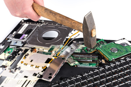 destroying laptop computer parts with a hammer