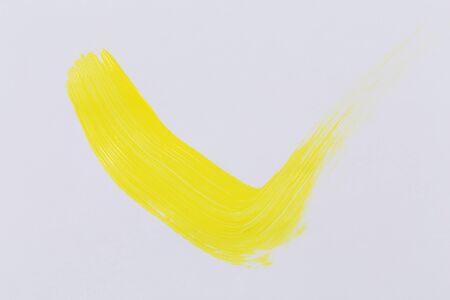 Yellow paint on white paper for background texture